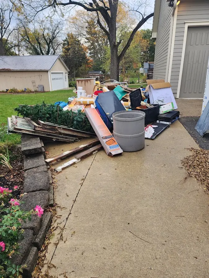 Dumpster being loaded with debris for Estate Cleanout Dumpster Rental in East Bakersfield